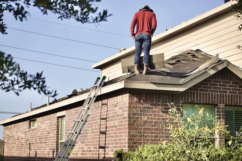 Professional roofer working on a residential roof in Eastland